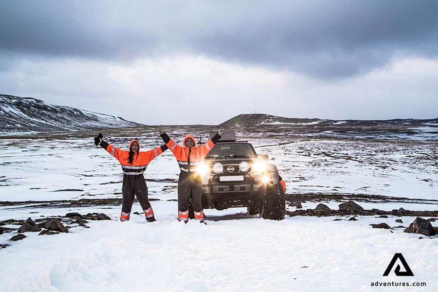 two happy friends on a winter jeep tour