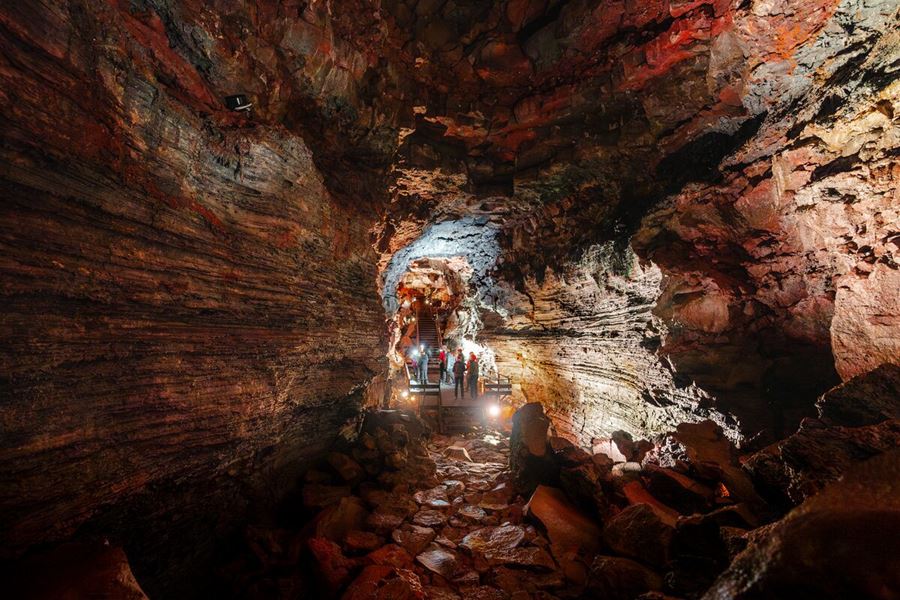 Tourists Inside A Lava Tunnel On An Expedition