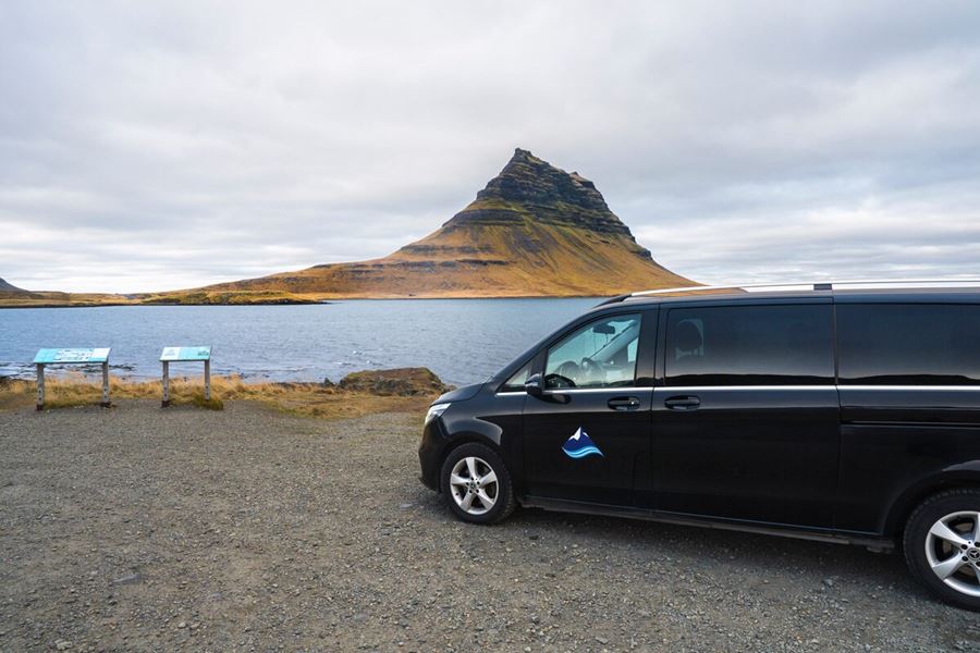A Car Standing In Front Of Kirkjufell Mountain