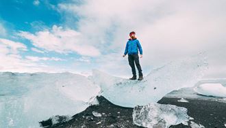 Man standing on a grounded iceberg