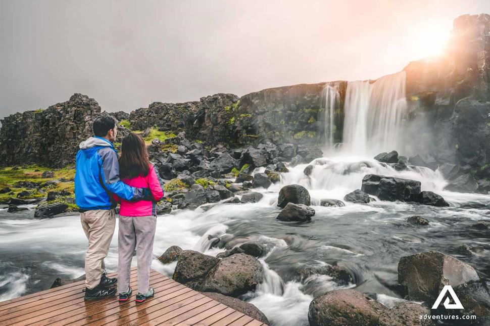 travellers near oxararfoss waterfall in Thingvellir