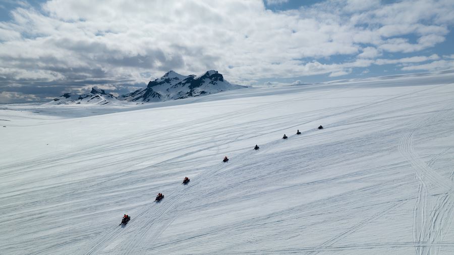 Group Riding Snowmobiles on Glacier