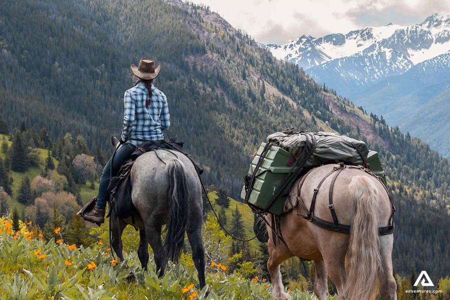 Woman on a horse enjoying mountain view