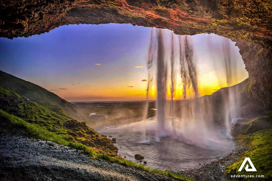 sunset behind seljalandsfoss waterfall