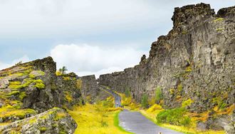 people walking the gravel path at thingvellir in iceland