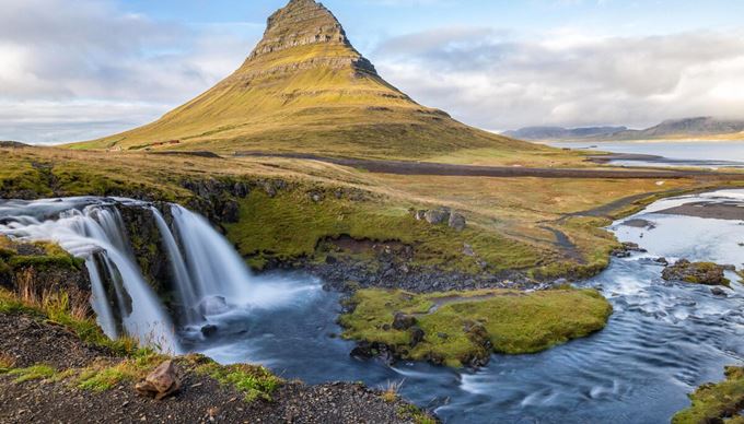 Kirkjufell mountain by Snaefellsnes in early spring, with two small waterfalls.