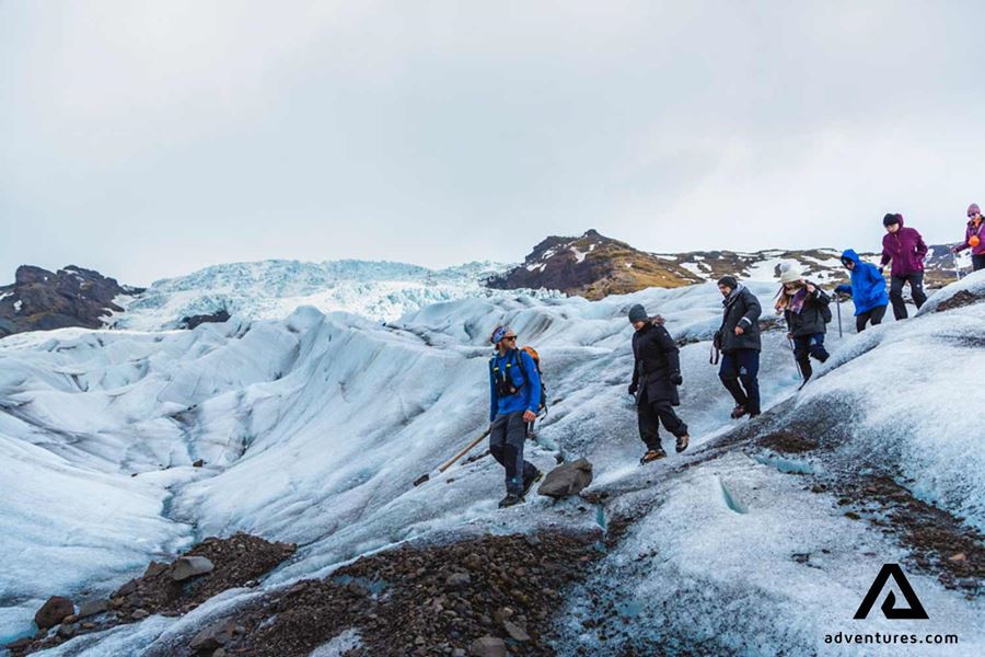 guide hiking on a glacier with a group