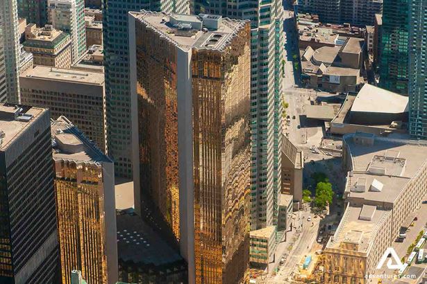 tall glass building view from cn tower in toronto