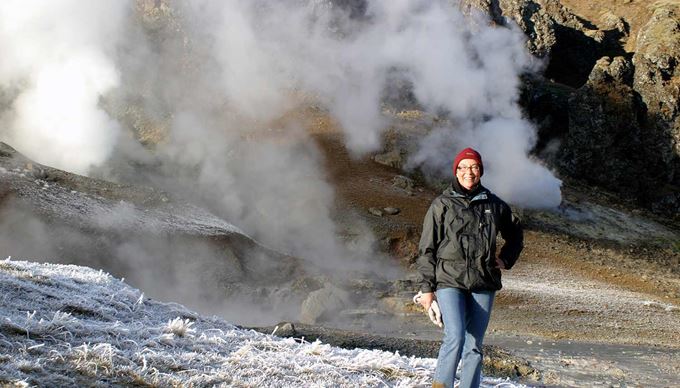 woman posing near steaming hot springs reykjadalur