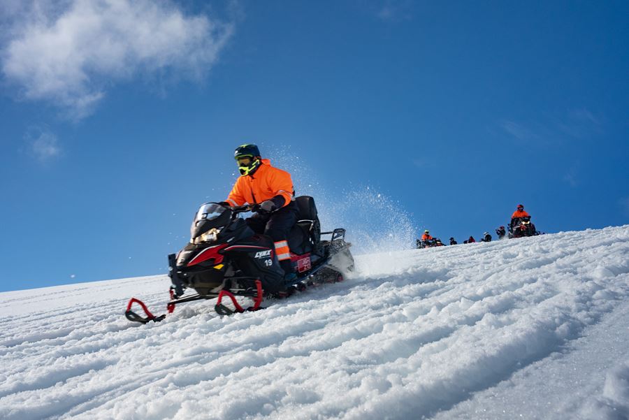 People Riding Snowmobiles