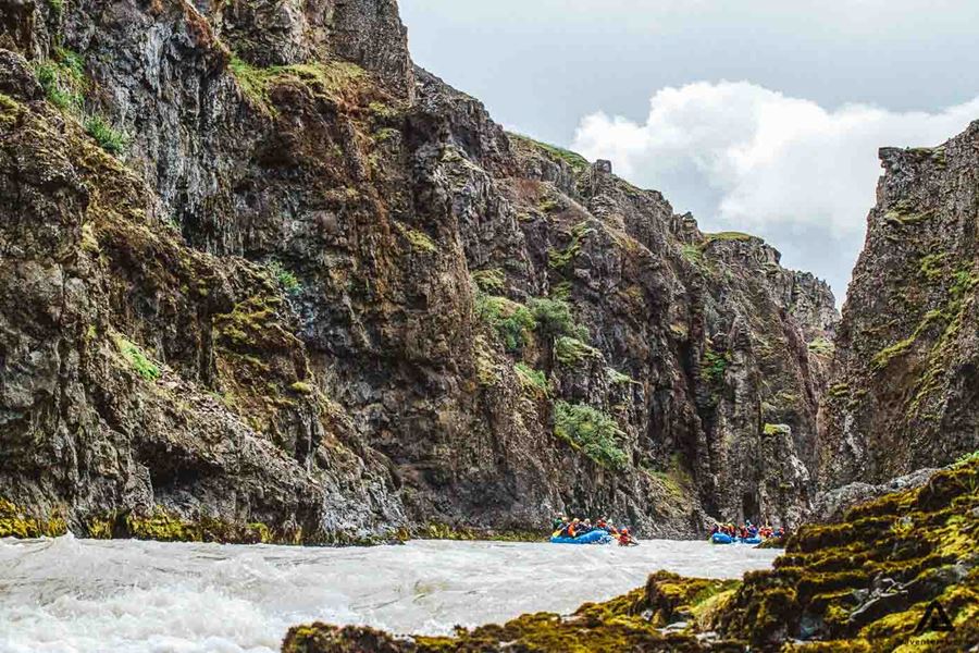 People Rafting Near Rocks Glacier River