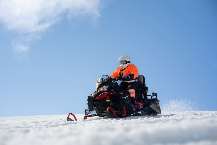 Riding Snowmobile on Glacier
