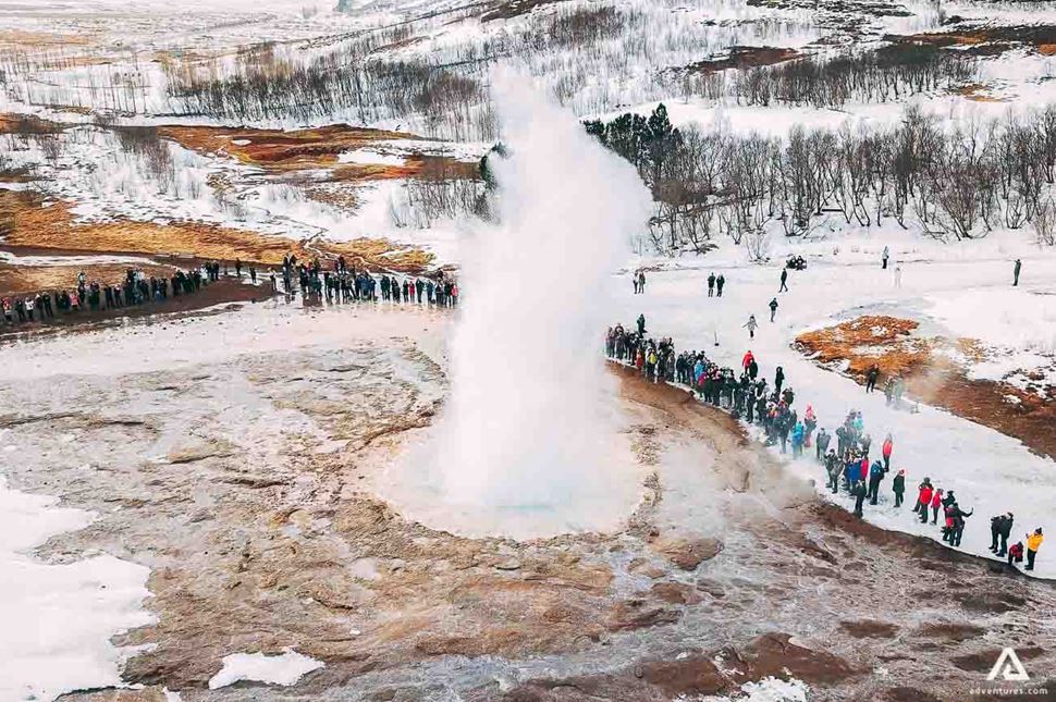 aerial view of geysir eruption in winter in iceland