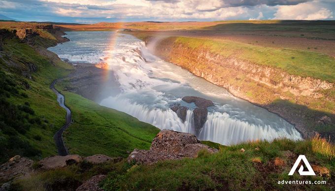 evening sun and rainbow at gullfoss waterfall