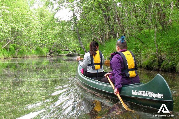 two people canoeing in river