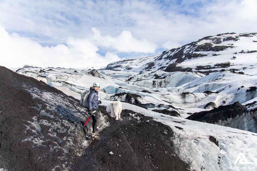 Woman and dog on a glacier