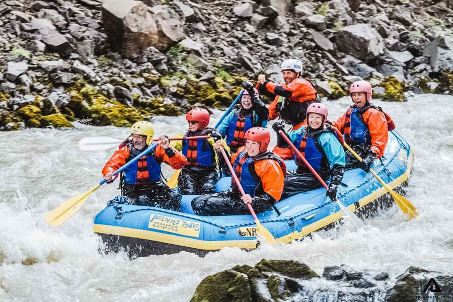 People Rafting Down Glacier River