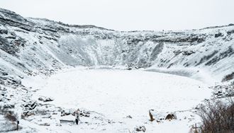 Tourists At Kerid Crater Covered In Snow in Iceland