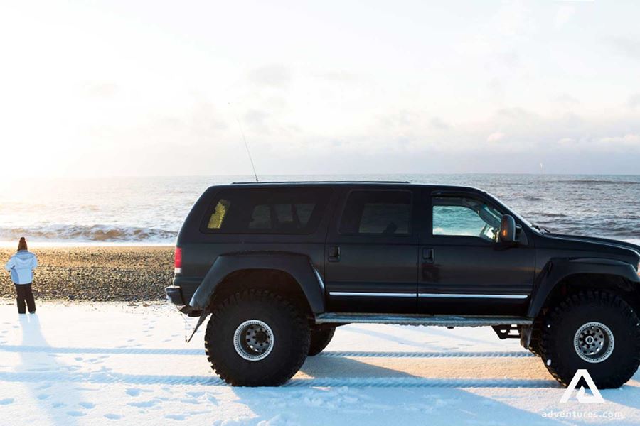 black super jeep in black sand beach