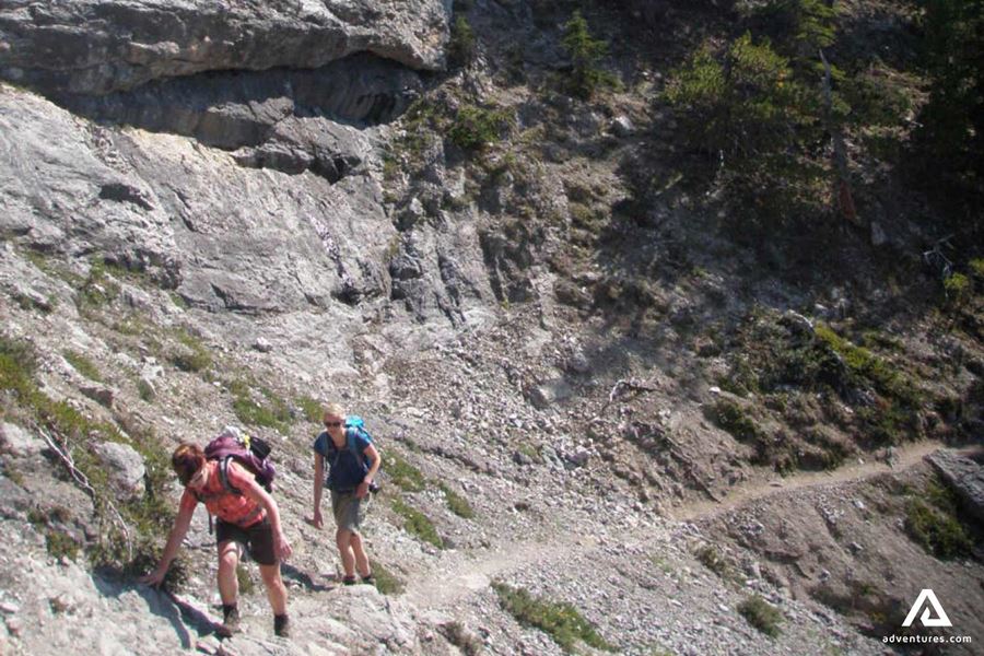 Two People Hiking on Cliffs