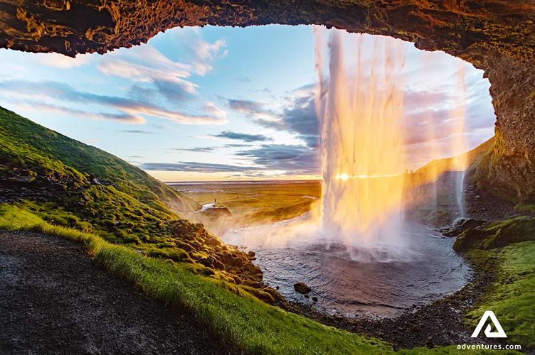 sunset at seljalandsfoss waterfall in the south coast